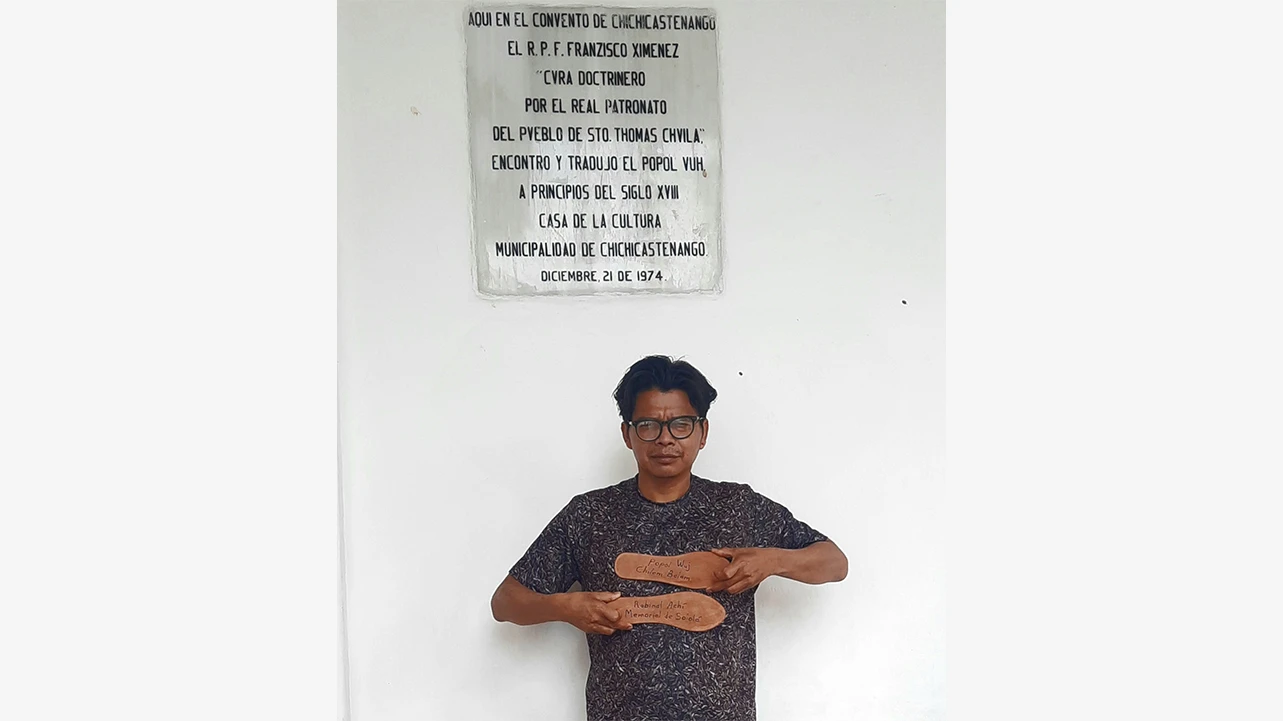 Benvenuto Chavajay en Chichicastenango, Guatemala, 2022. En la placa de mármol se lee: &quot;Aquí en el convento de Chichicastenango […] encontró y tradujo el Popol Wuj&quot;. Fotografía cortesía del artista