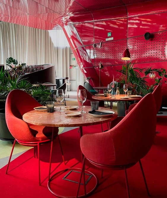 A pair of red armchairs and a table at the NuBeL restaurant